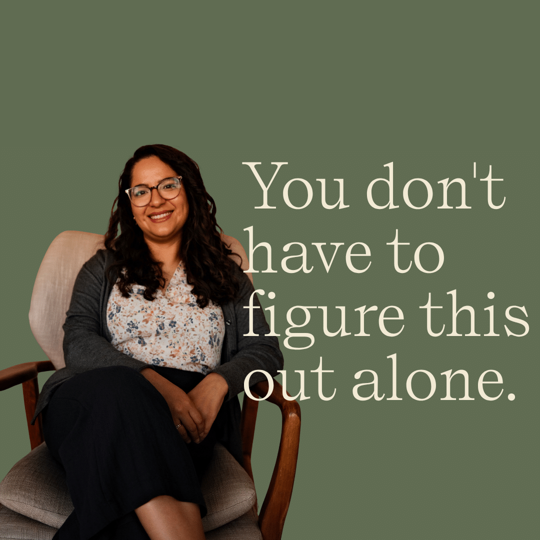 Dr. C. Julieta Aguilera Rice, PhD, licensed psychologist, seated in a therapy chair against a sage green background at Coastal Therapy Group's Carlsbad office